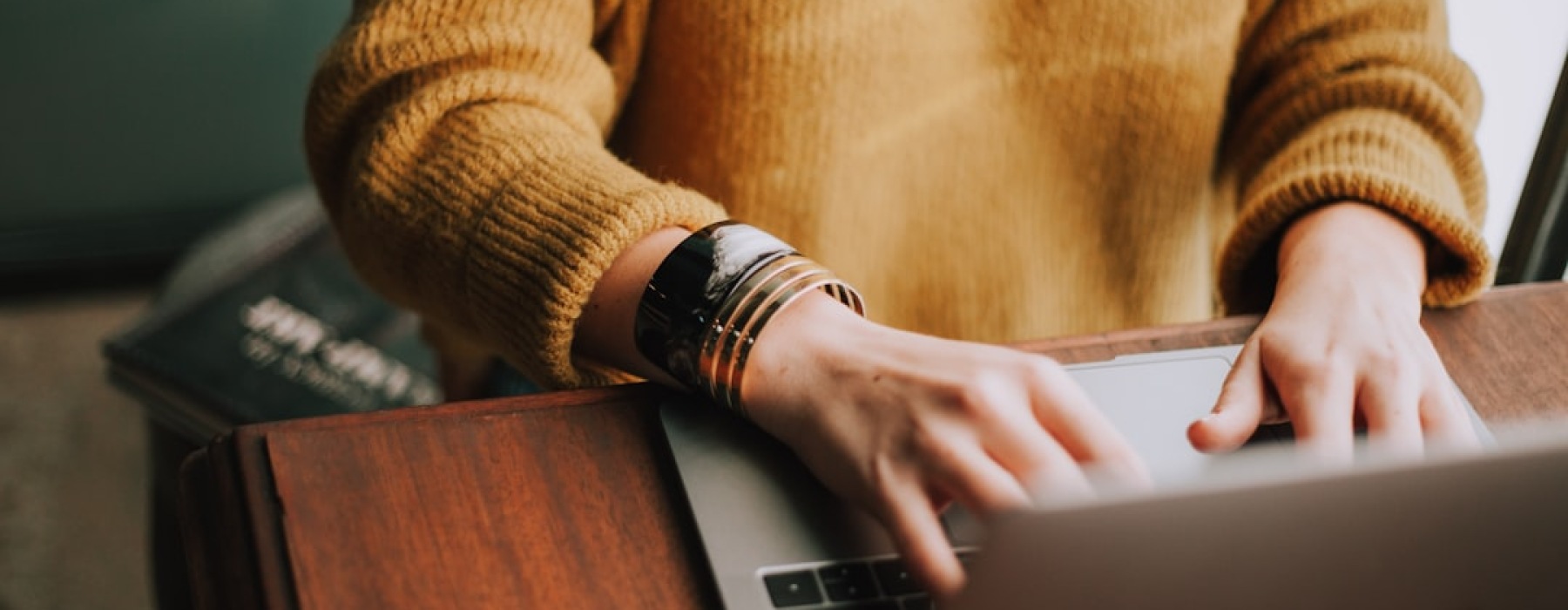 Person using a laptop to filter apartment listings for pet-friendly properties