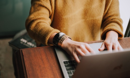 Person using a laptop to filter apartment listings for pet-friendly properties